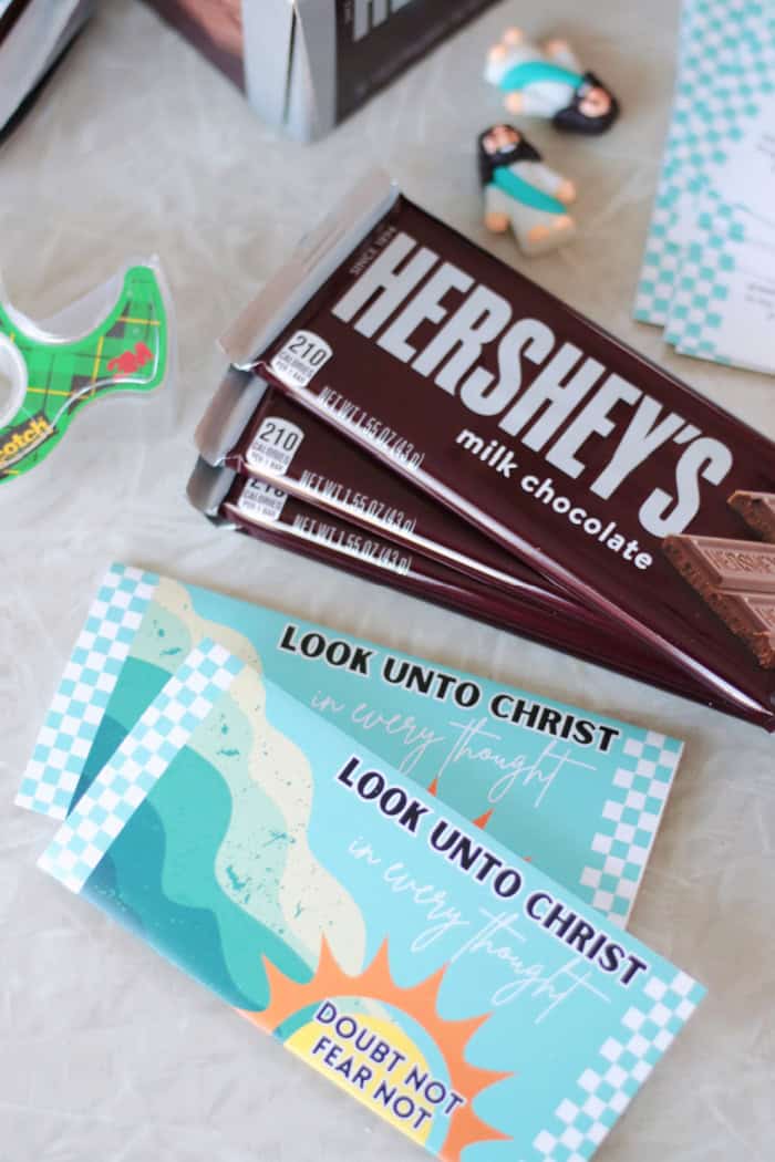 stack of "look unto christ" candy bar wrappers and stack of candy bars