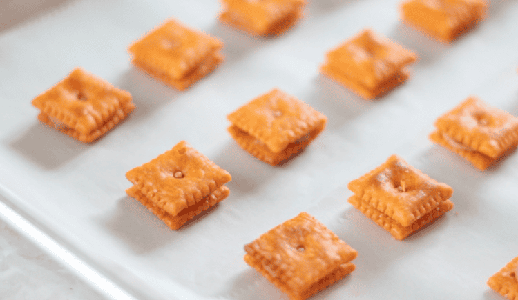 cheez its sandwiched with peanut butter on baking sheet