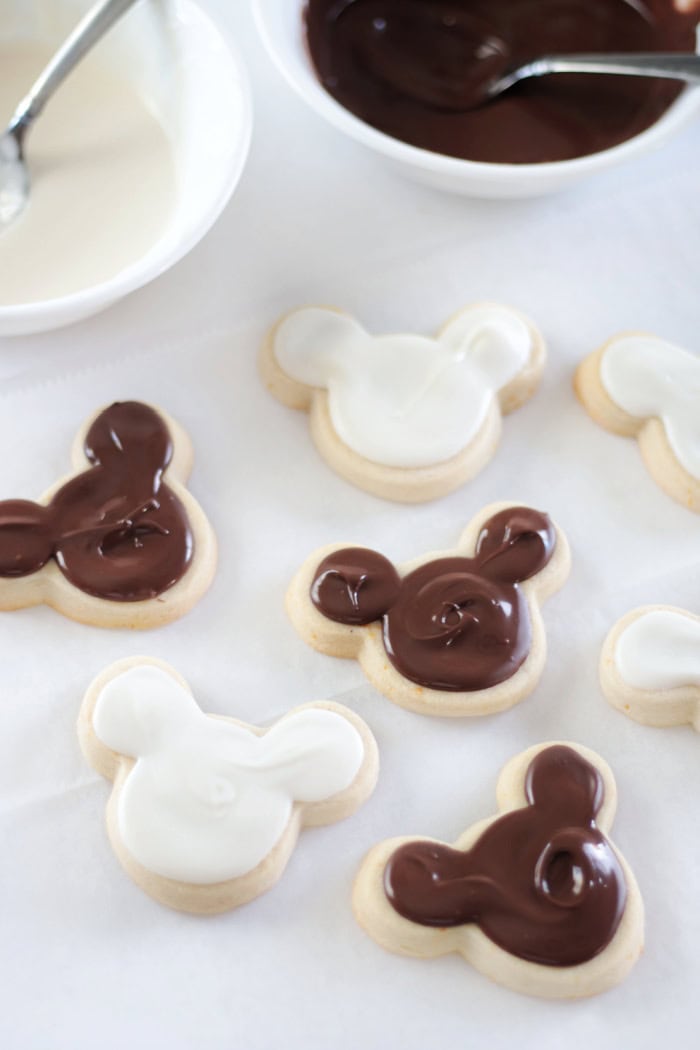 bowls of white chocolate and chocolate and coated cookies