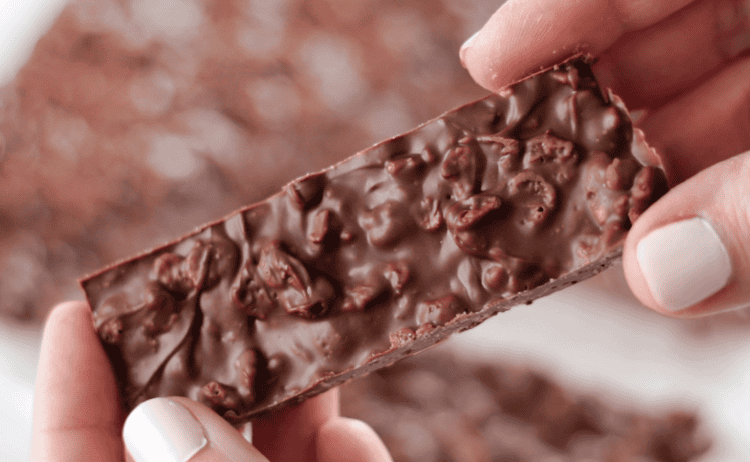 hand holding meltaway crunch bar