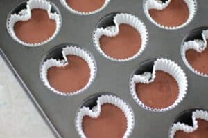 cupcakes in pan with small balls of foil to create heart shape