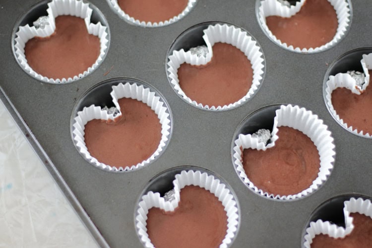 cupcakes in pan with small balls of foil to create heart shape