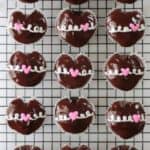 cooling rack with 15 hostess heart cupcakes on it