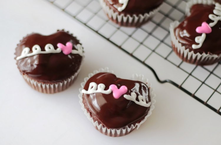 heart cupcakes on table and cupcakes on cooling rack