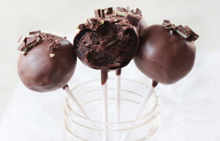 jar with 3 cake pops, one with a bite taken from it