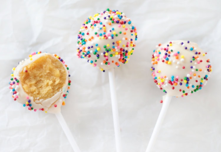 3 birthday cake pops, one with bite taken out