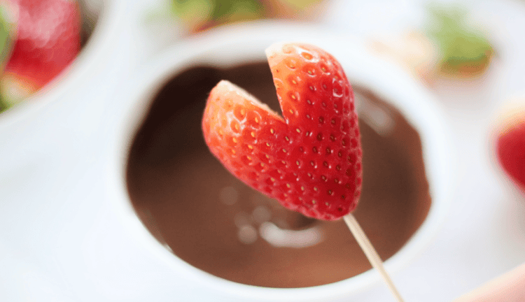 heart shaped strawberry and bowl of dipping chocolate