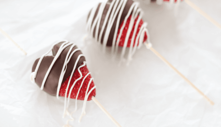 parchment paper with dipped strawberries on it