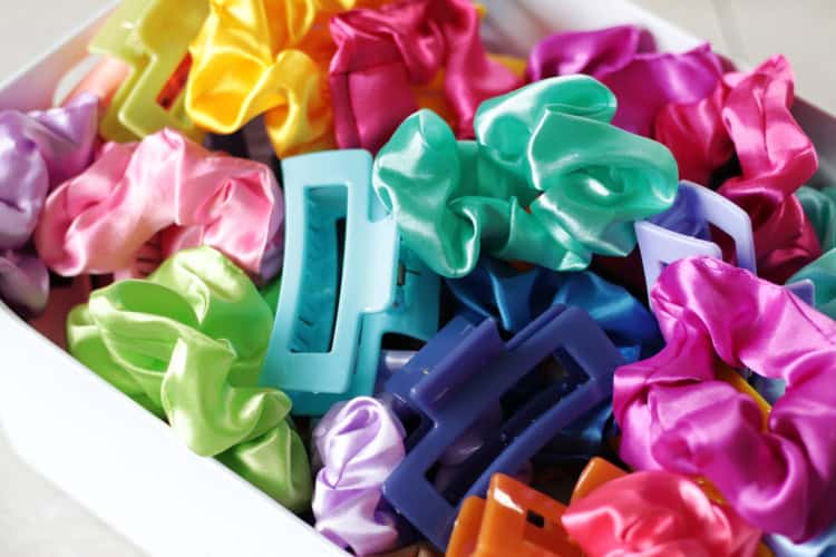 container of colorful scrunchies and hair clips