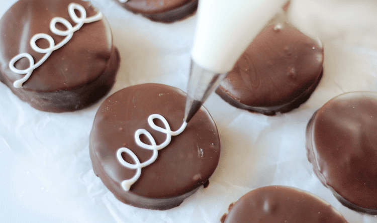 melted white chocolate piped onto eggs