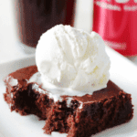 slice of coca cola cake with scoop of vanilla ice cream on plate