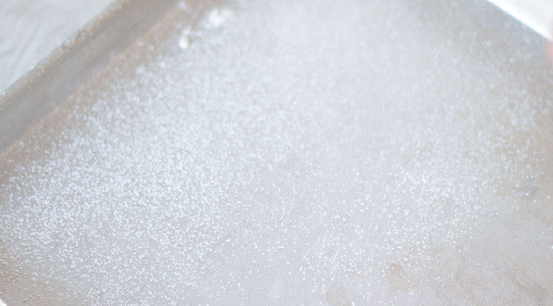 Baking sheet dusted in powdered sugar.