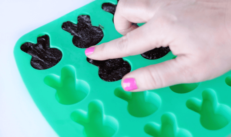 silicone bunny mold filled with mashed brownies