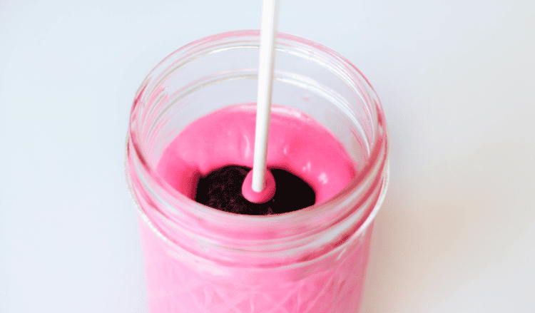 brownie dipped in jar of melted candy melts
