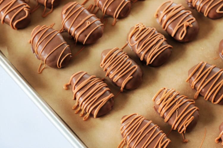scotcheroo eggs on baking sheet with parchment paper