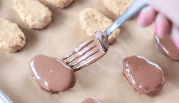 fork transferring dipped egg onto baking sheet