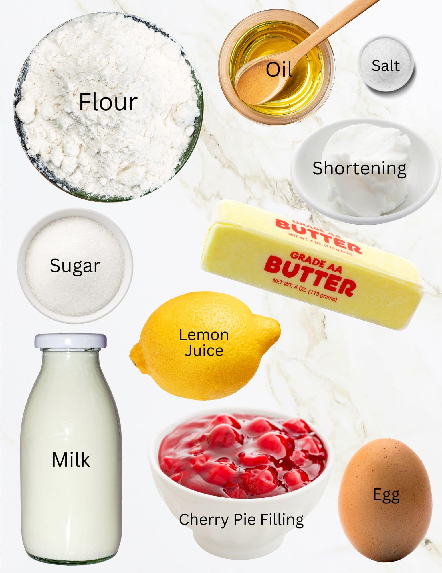 Bowls of flour, oil, salt, shortening, sugar, a stick of butter, lemon, bottle of milk, bowl of cherry pie filling and an egg.