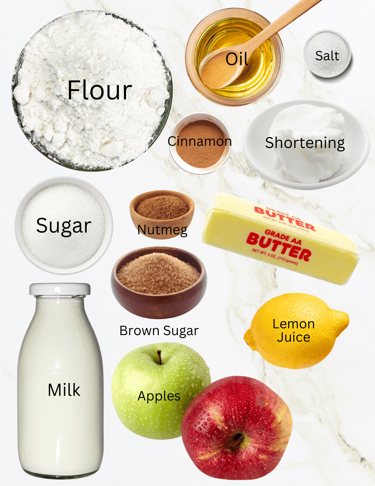 Bowls of flour, oil, salt, shortening, sugar, brown sugar, cinnamon and nutmeg next to bottle of milk, two apples, lemon, and stick of butter.