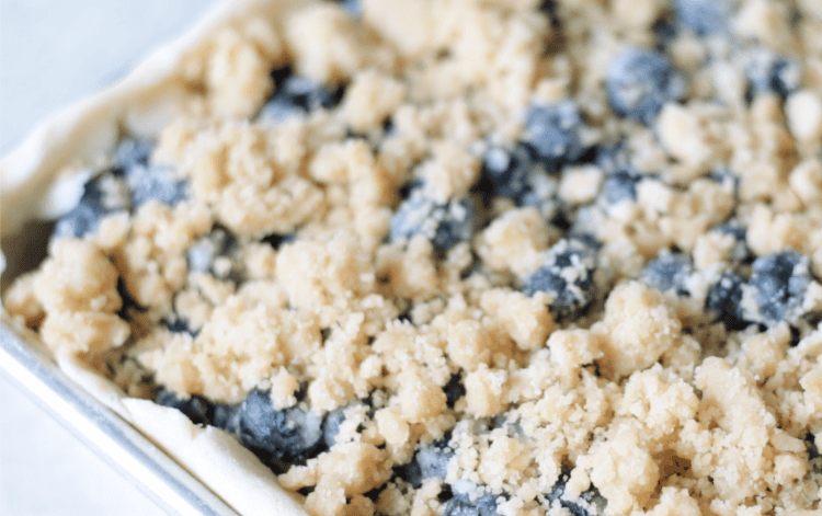 unbaked blueberry crumble slab pie in pan