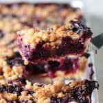 Blueberry slab pie on a spatula.
