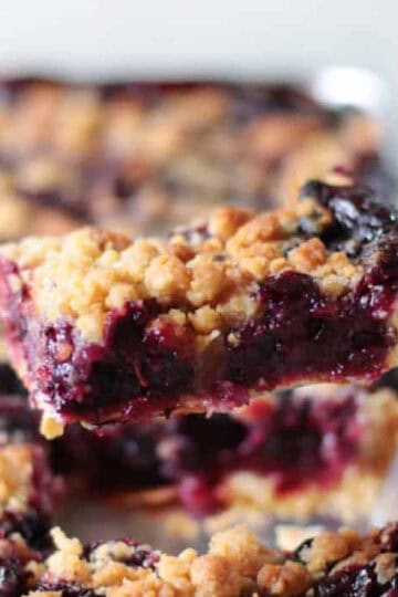 Slice of blueberry pie on a spatula.