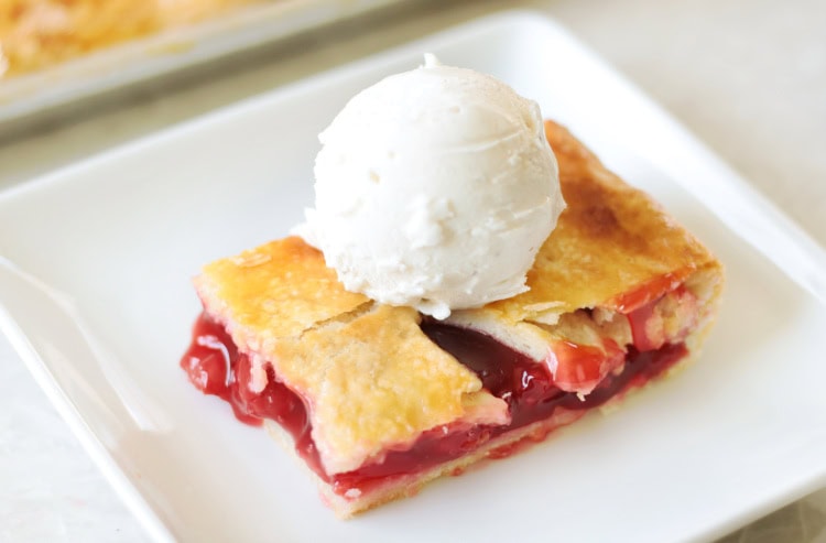 slab of cherry pie with scoop of vanilla ice cream