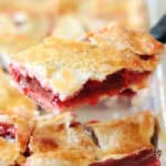 Slice of cherry pie on a metal spatula.