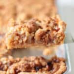 Slice of apple crumb pie on spatula.