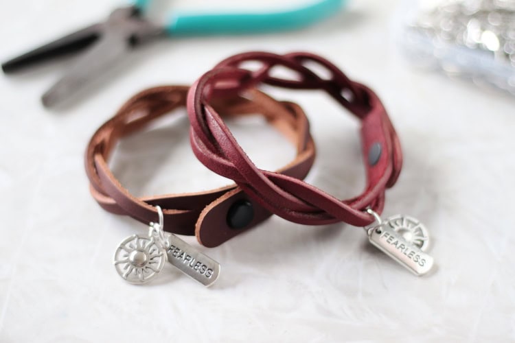 two brown mystery brade leather bracelets with charms