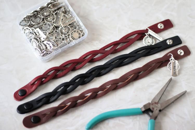 3 leather bracelets with jewelry pliers and box of charms