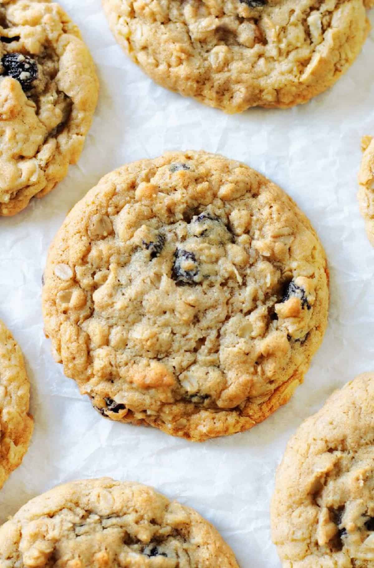 Oatmeal raisin cookies on parchment paper.