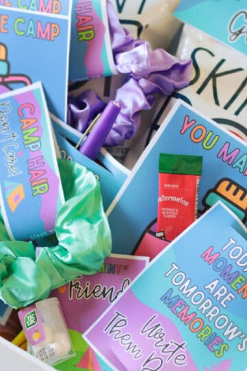 Bin of tuck in treats attached to printable tags.