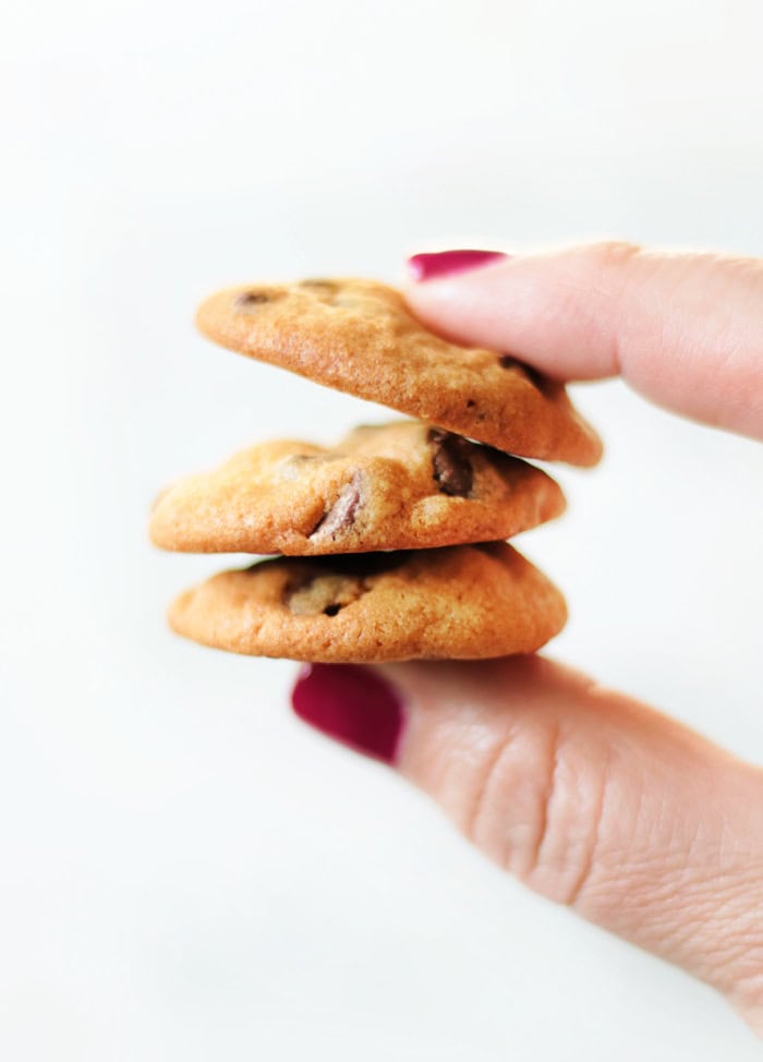 hand holding 3 copycat famous amos chocolate chip cookies