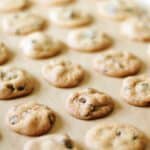 baking sheet with parchment paper and batch of copycat famous amos chocolate chip cookies
