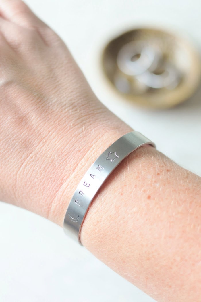 arm with stamped metal bracelet