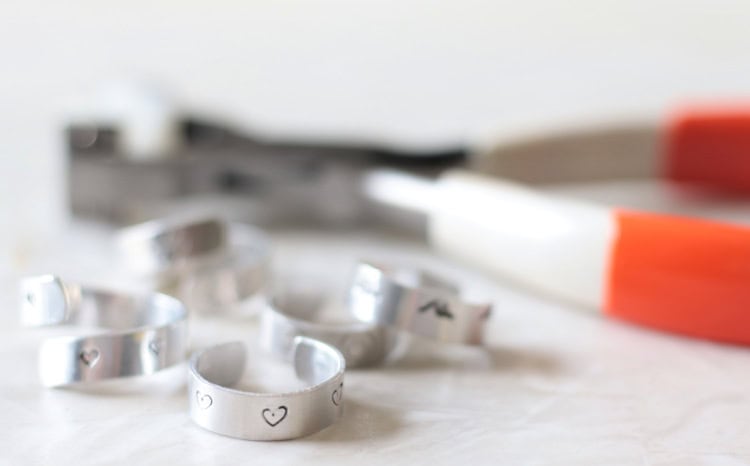 easy hand stamped rings on table next to ring bending tool