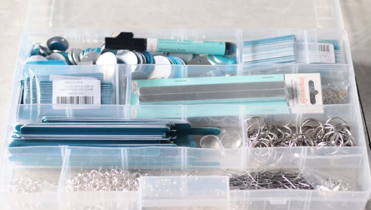 plastic organizer full of metal jewelry blanks for stamping