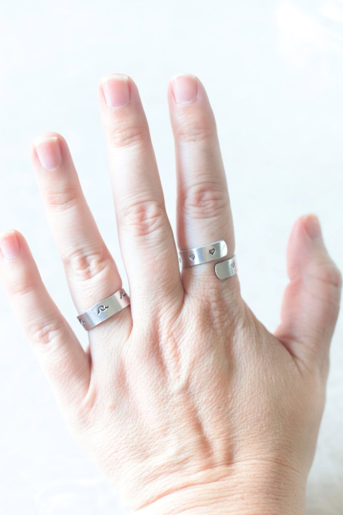 hand wearing 2 stamped rings