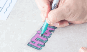 hand coloring back of shrinky dink sheet