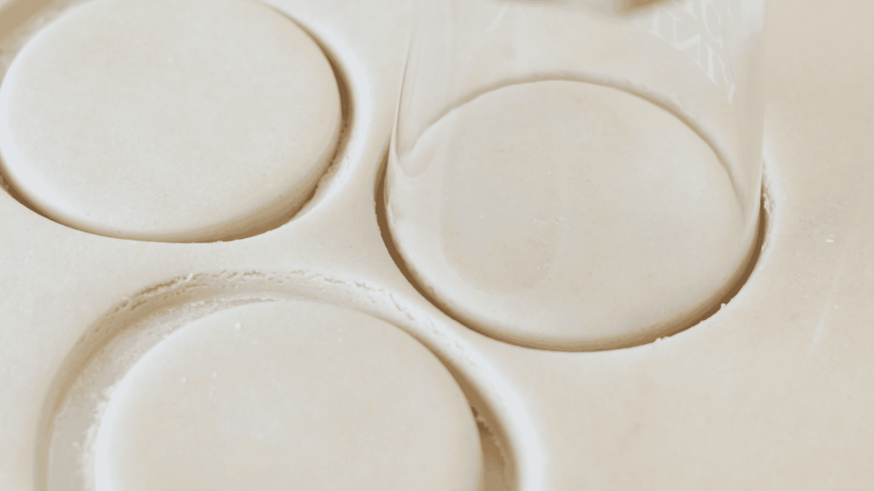 cookie dough rolled out and cut into circles