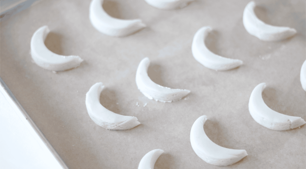 Unbaked lemon cookies on a baking sheet with parchment paper.