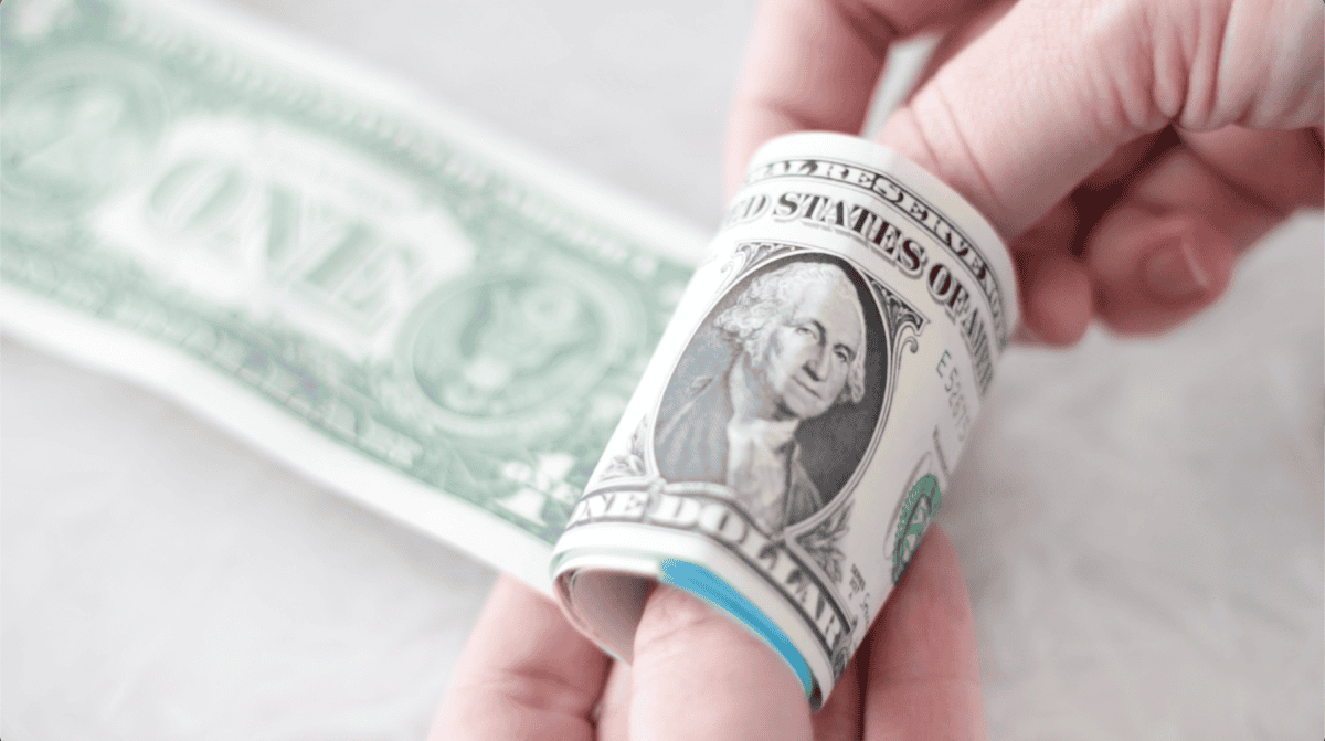 Doller bills taped together and rolled up.