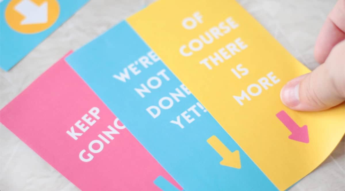 Printable tags cut out and stacked next to eachother on table.