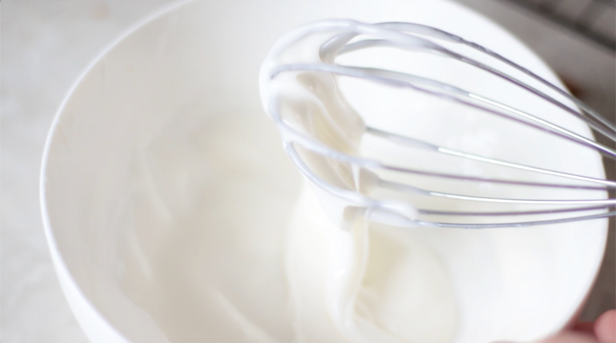 Bowl of glaze and whisk.