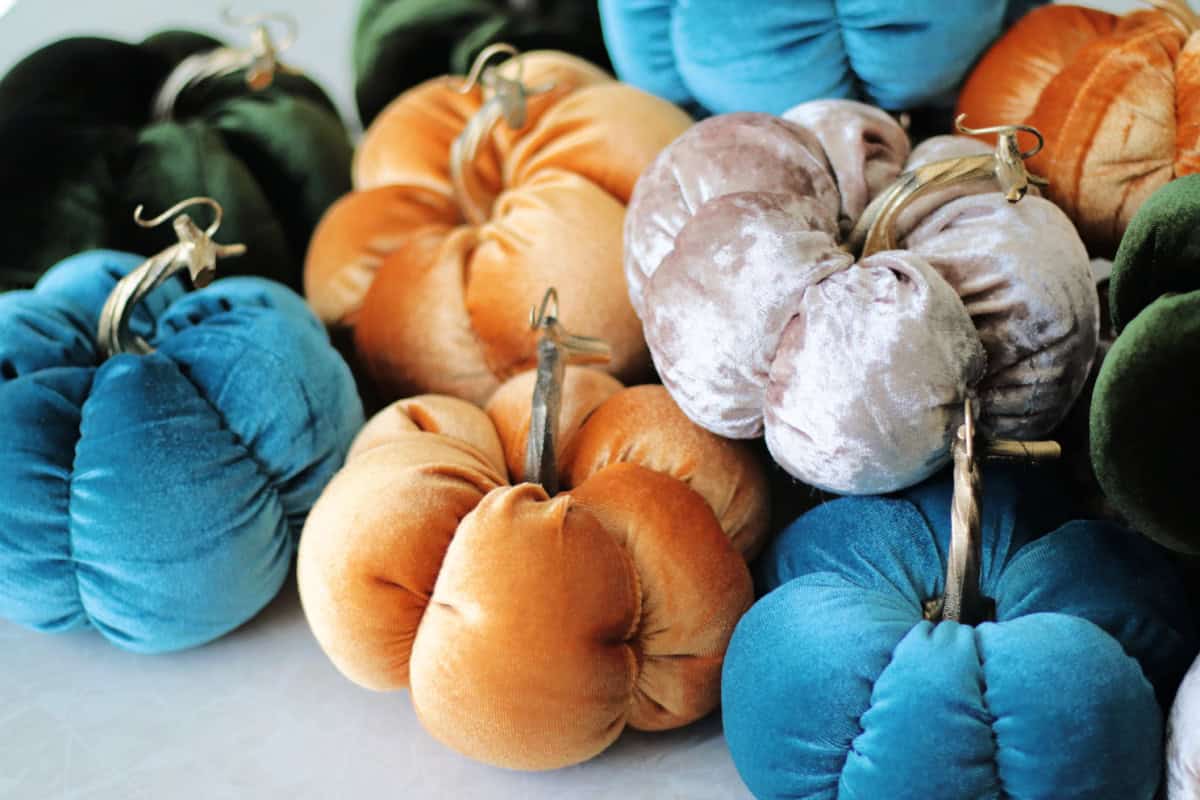 Velvet fabric pumpkins with plastic stems.