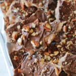 Broken pieces of Christmas crack on a baking sheet.