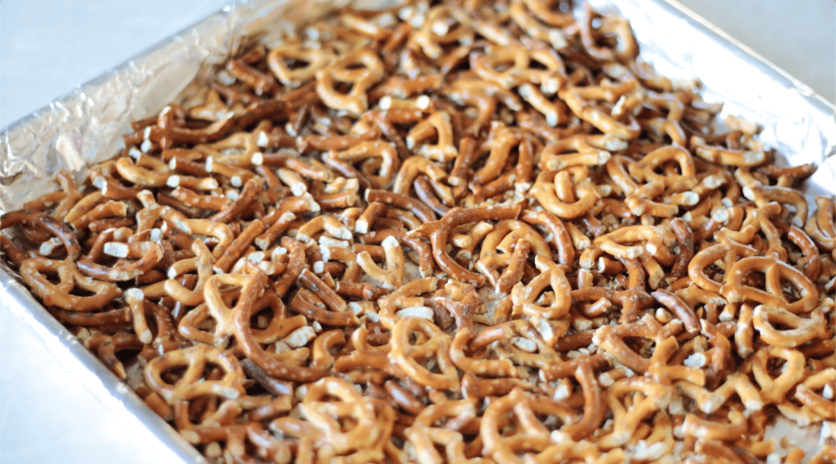 Foil lined baking sheet with chopped pretzels.