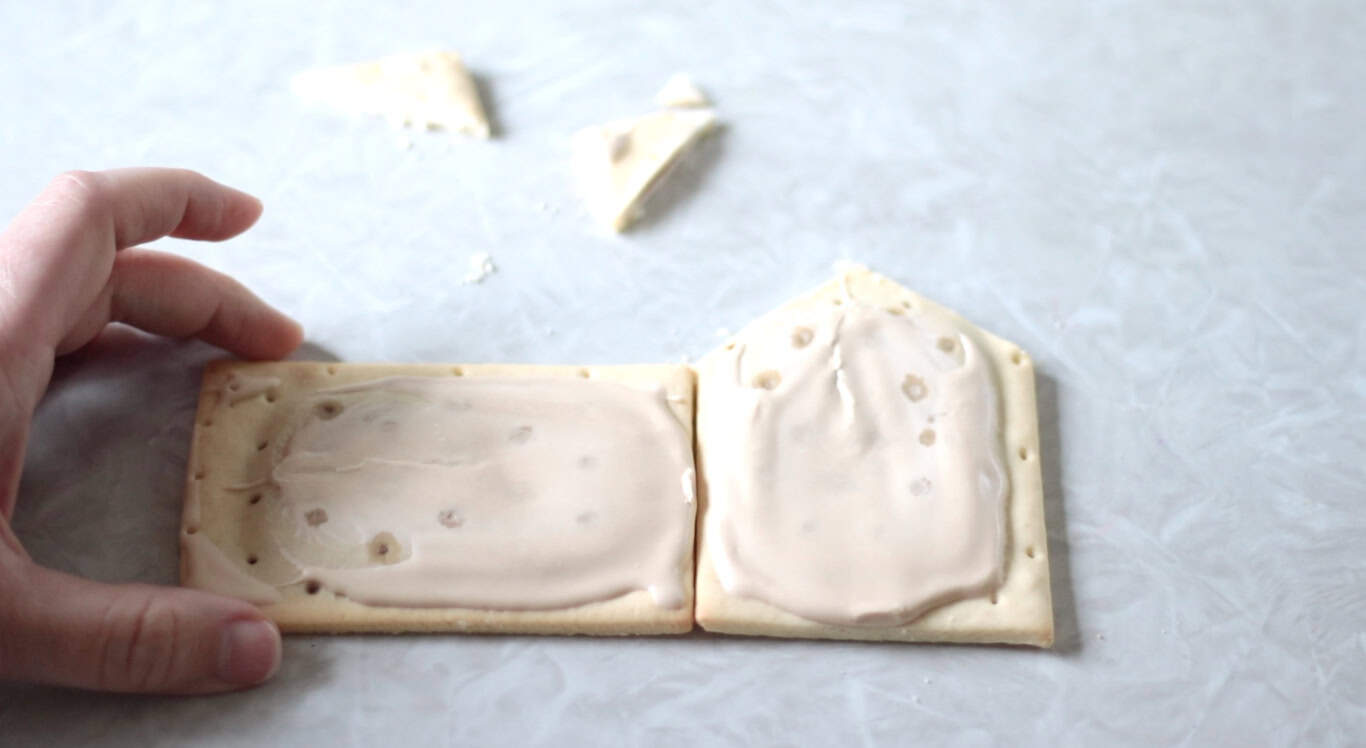 Two pop tarts, one turned on it's side, the other cut to a roof angle.