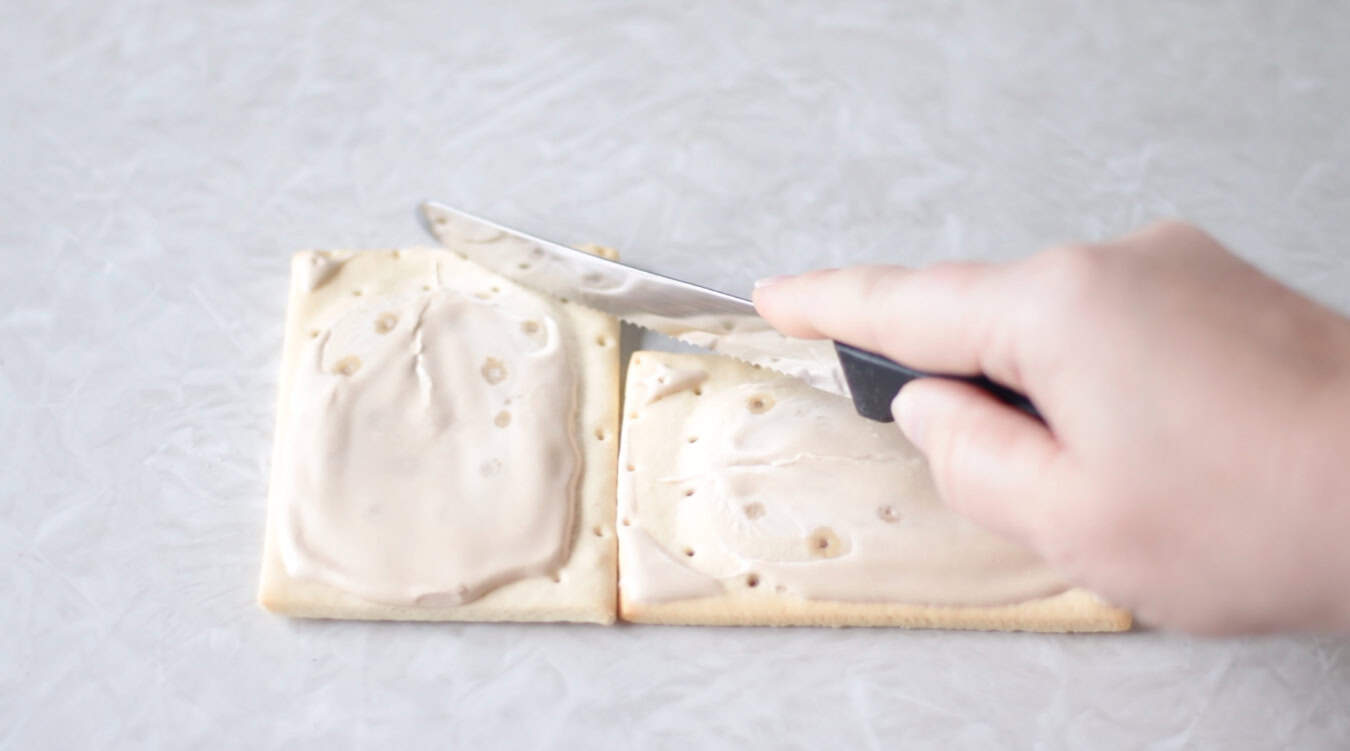 Knife cutting a pop tart on an angle.