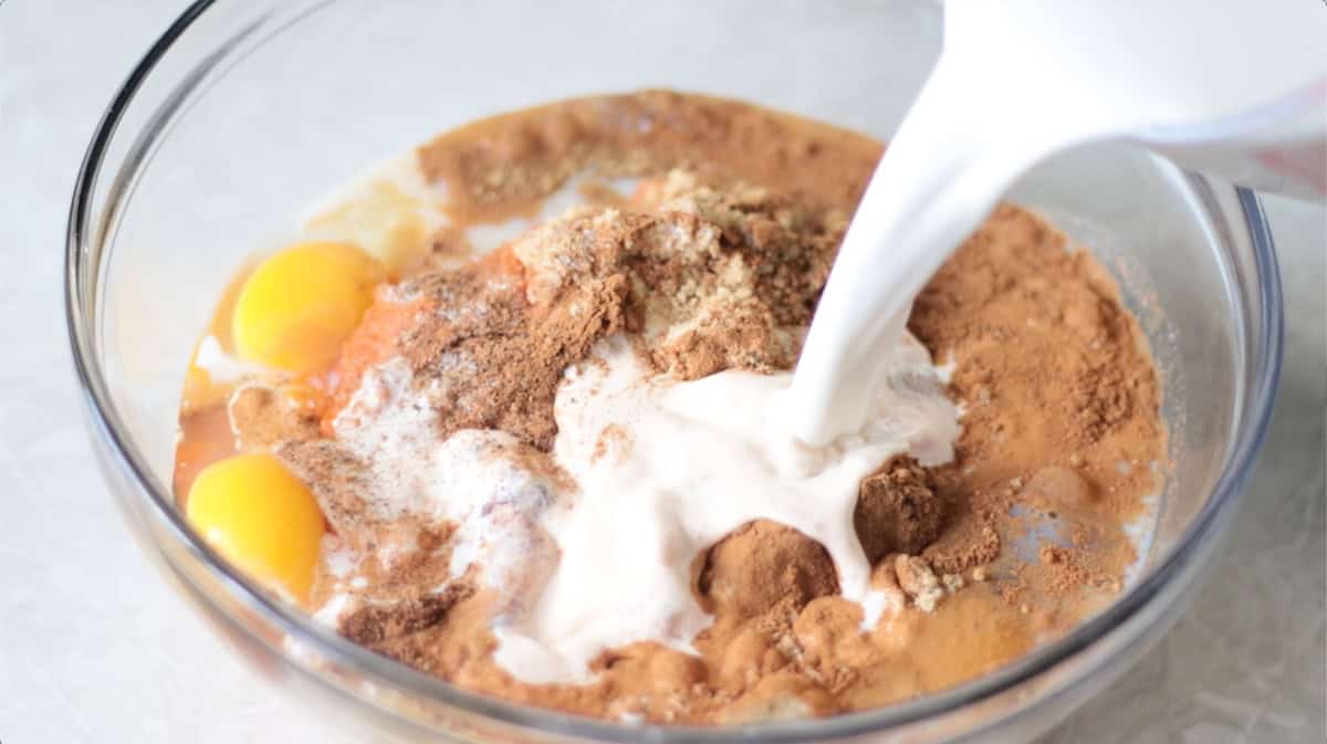 Mixing bowl with half and half, spices, eggs, sugar and pumpkin puree.